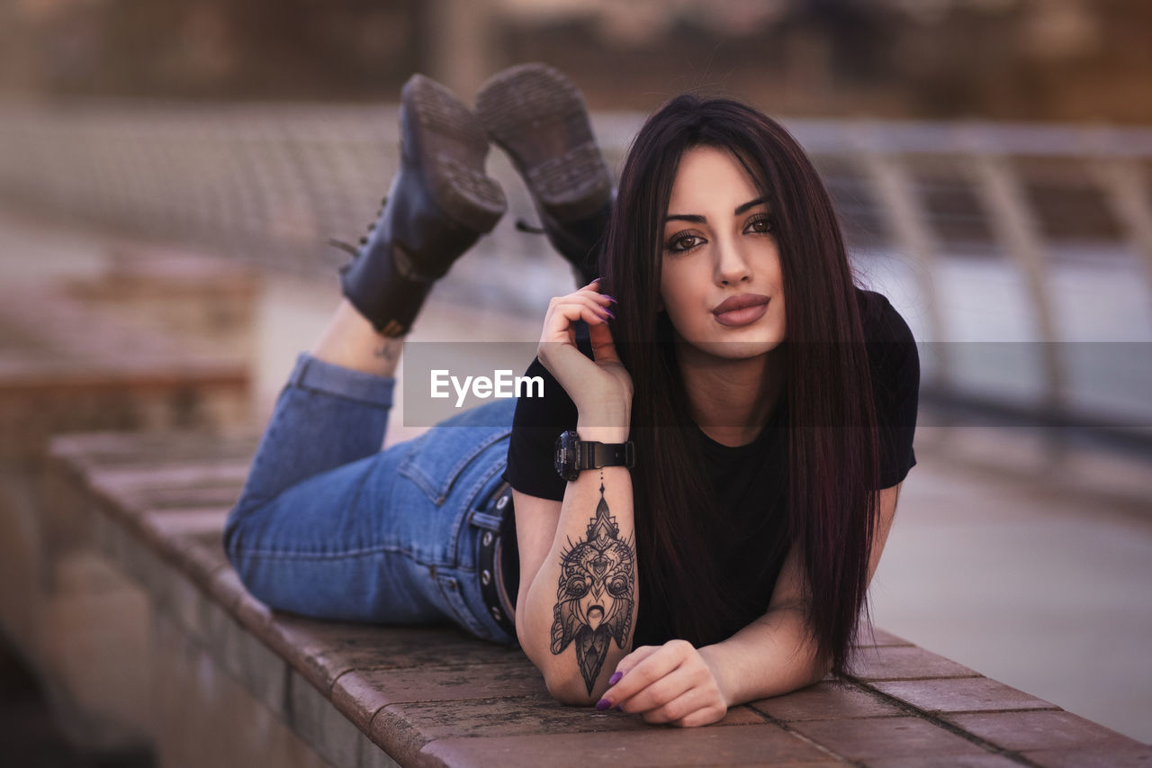 Portrait of young woman sitting outdoors