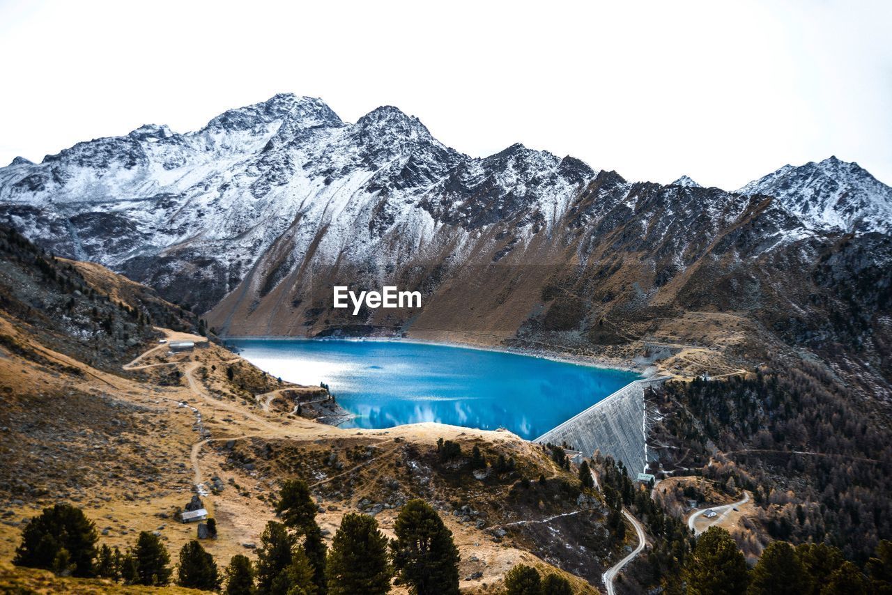 Scenic view of lake and mountains against clear sky