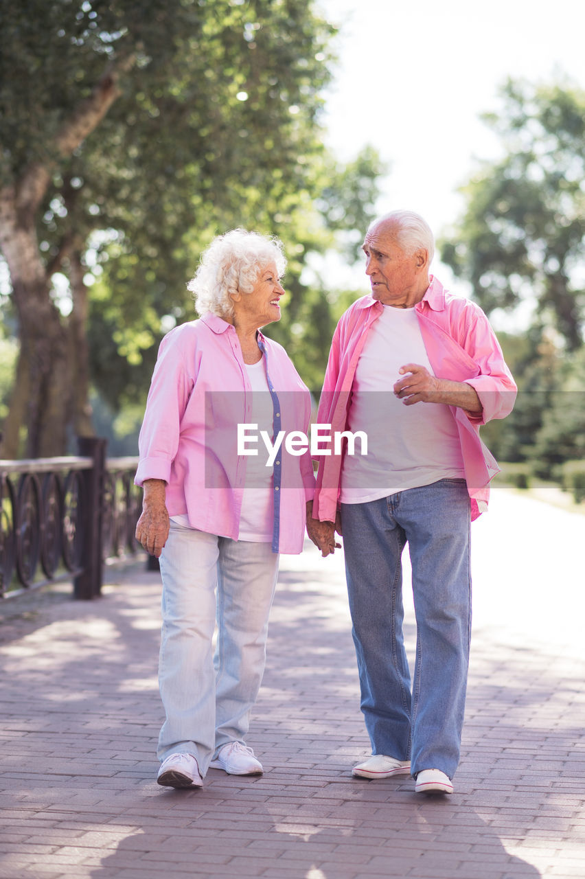 rear view of couple standing on footpath