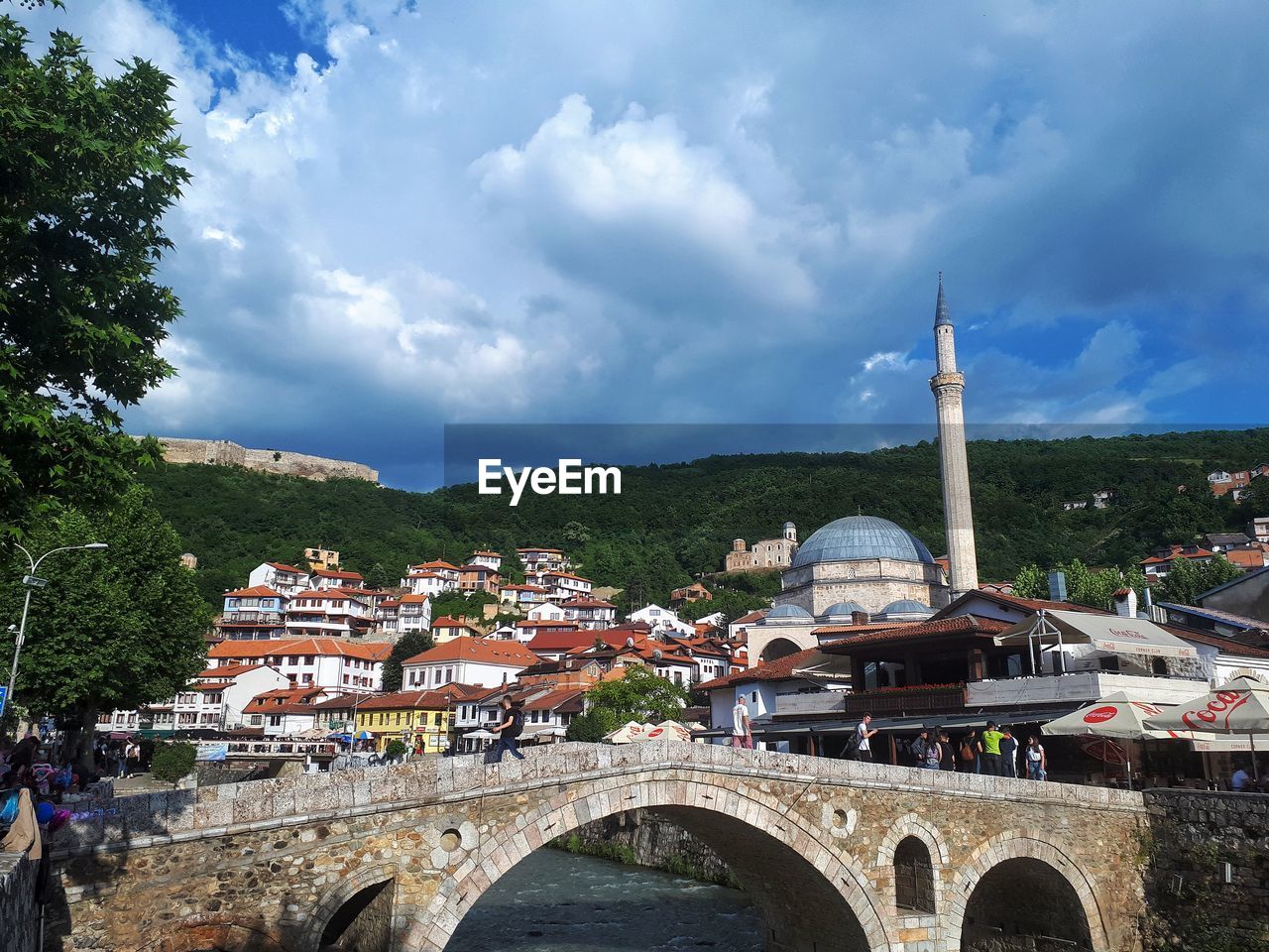 VIEW OF ARCH BRIDGE WITH BUILDINGS AGAINST SKY