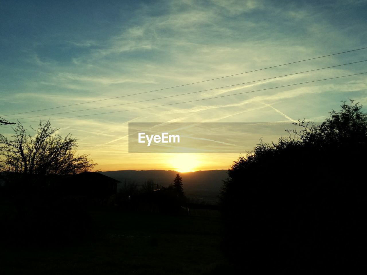 SCENIC VIEW OF SILHOUETTE TREES AGAINST SKY AT SUNSET