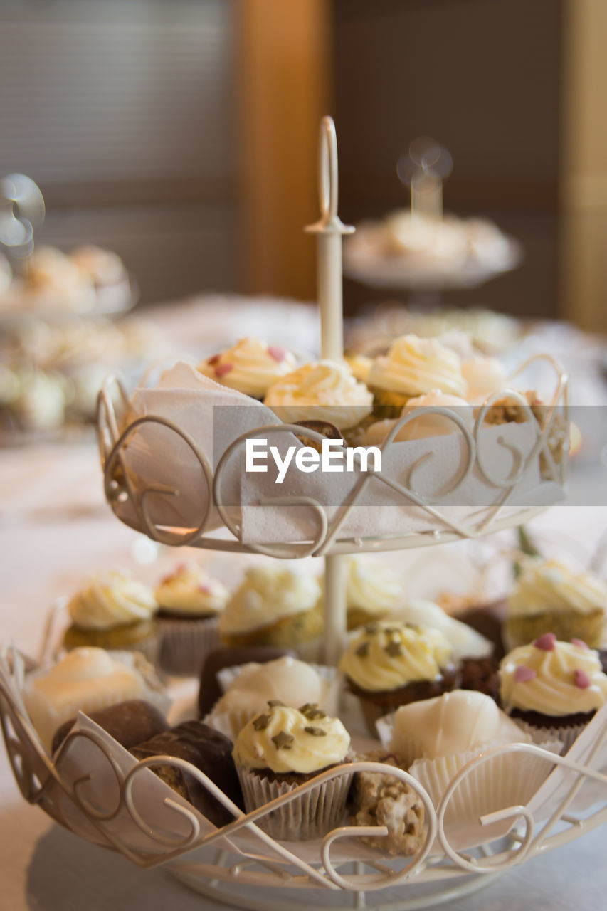 Cup cakes on stand at table