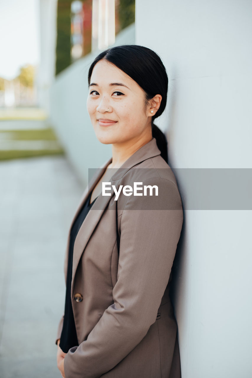 Portrait of smiling businesswoman standing in office