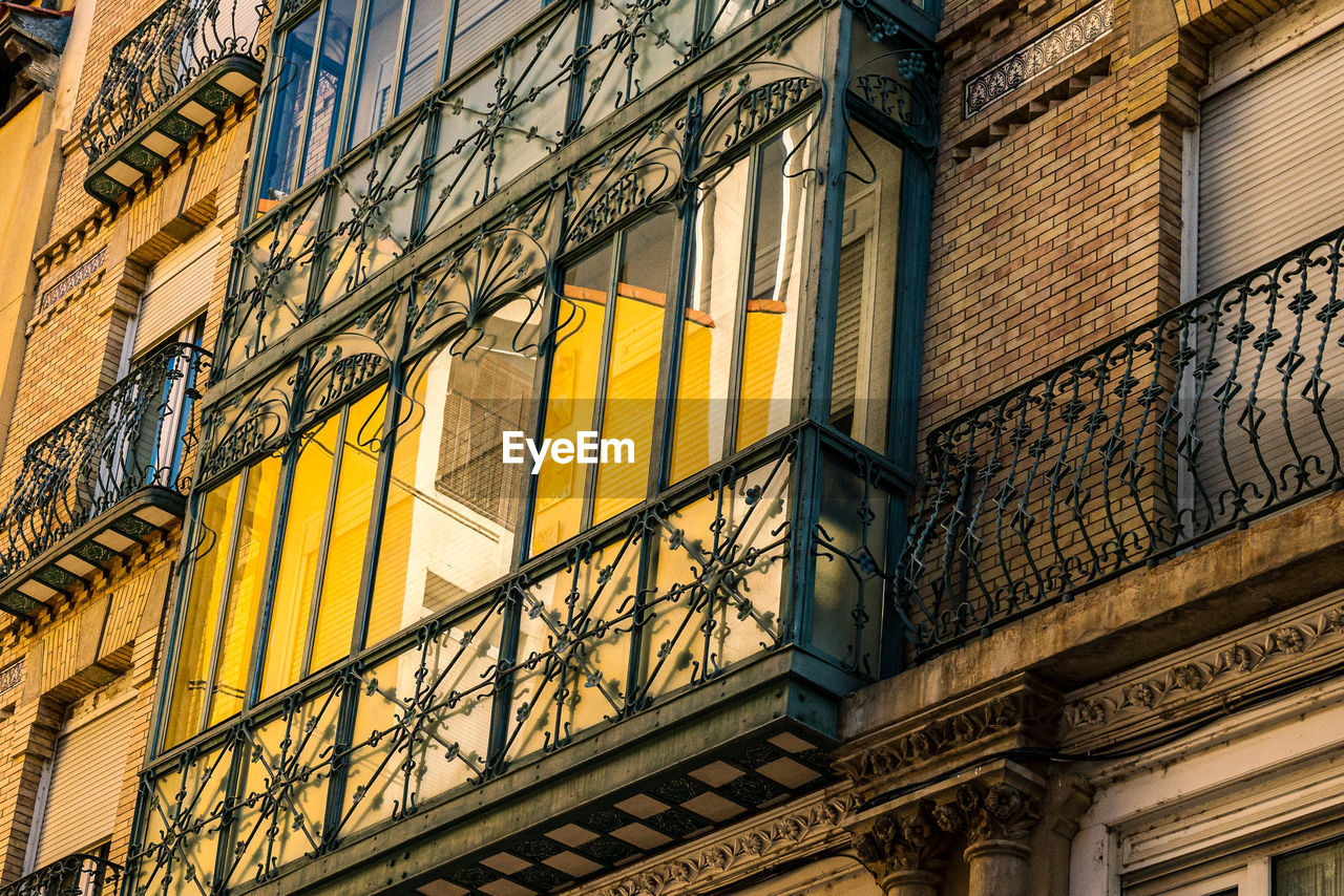 Low angle view of building and glass balconette