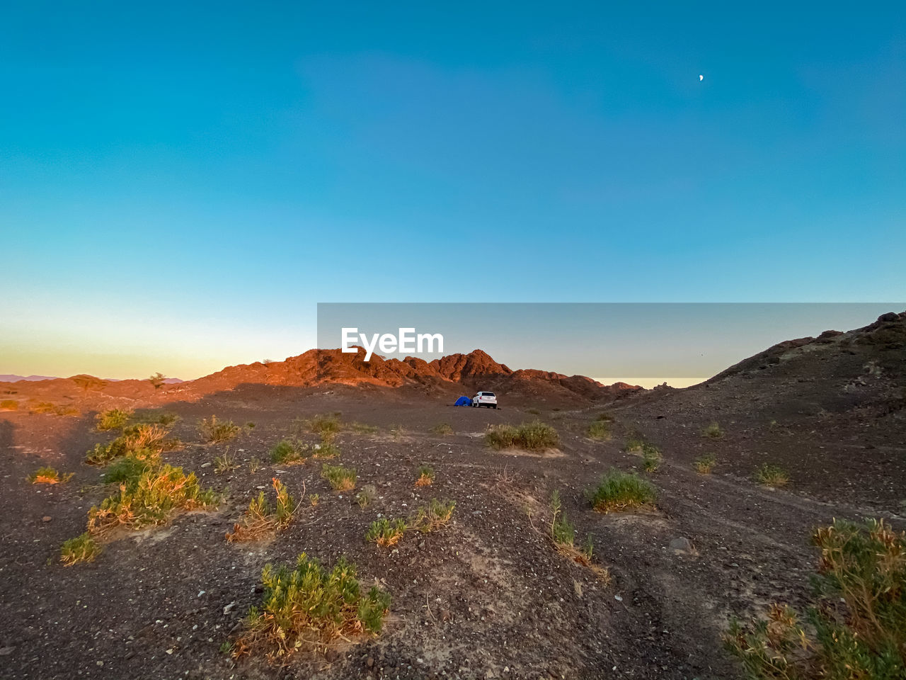 SCENIC VIEW OF LANDSCAPE AND MOUNTAINS AGAINST BLUE SKY