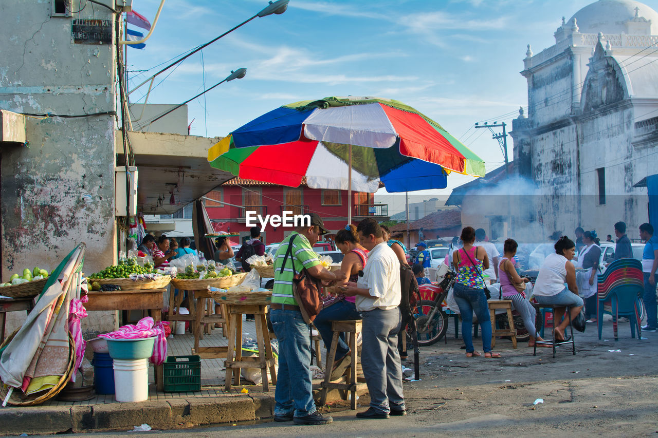 PEOPLE AT MARKET STALL