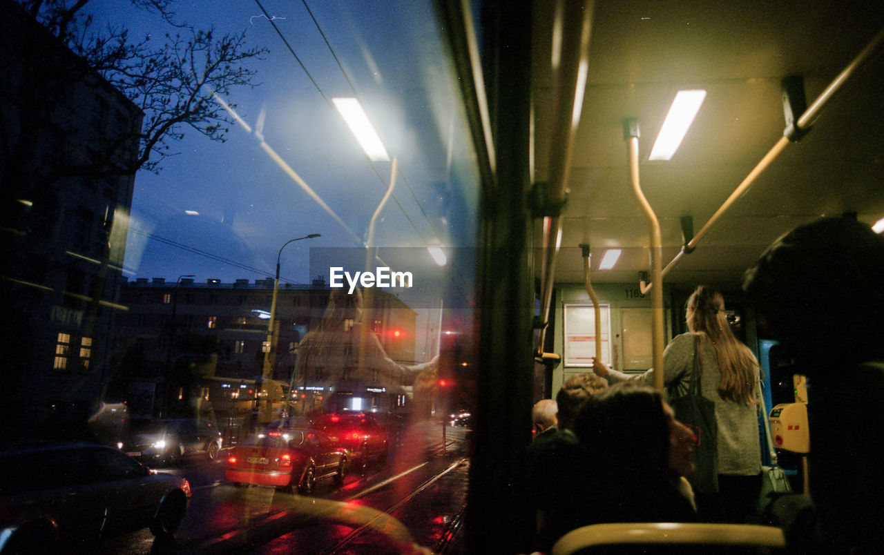 People on illuminated street at night