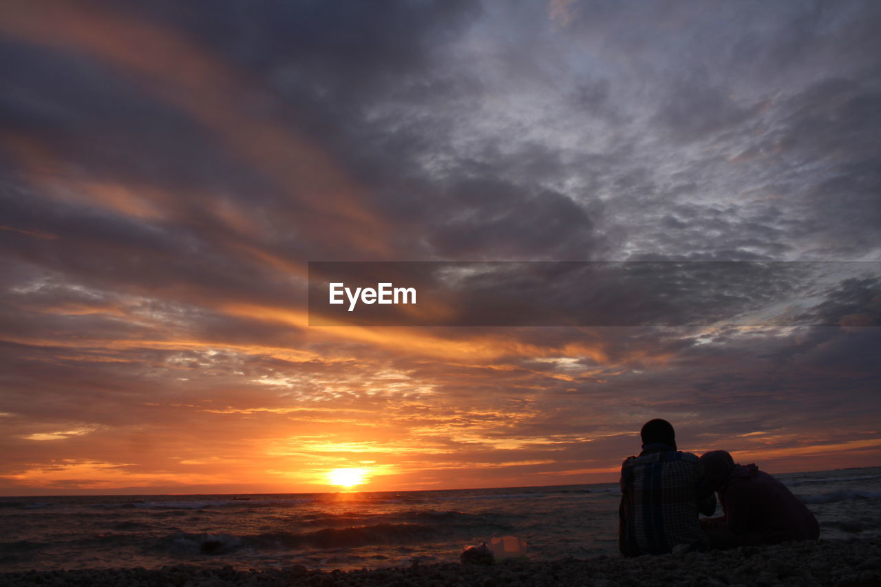 SCENIC VIEW OF SEA AGAINST ORANGE SKY