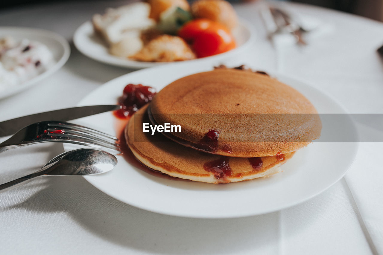 Close-up of pancakes in plate on table