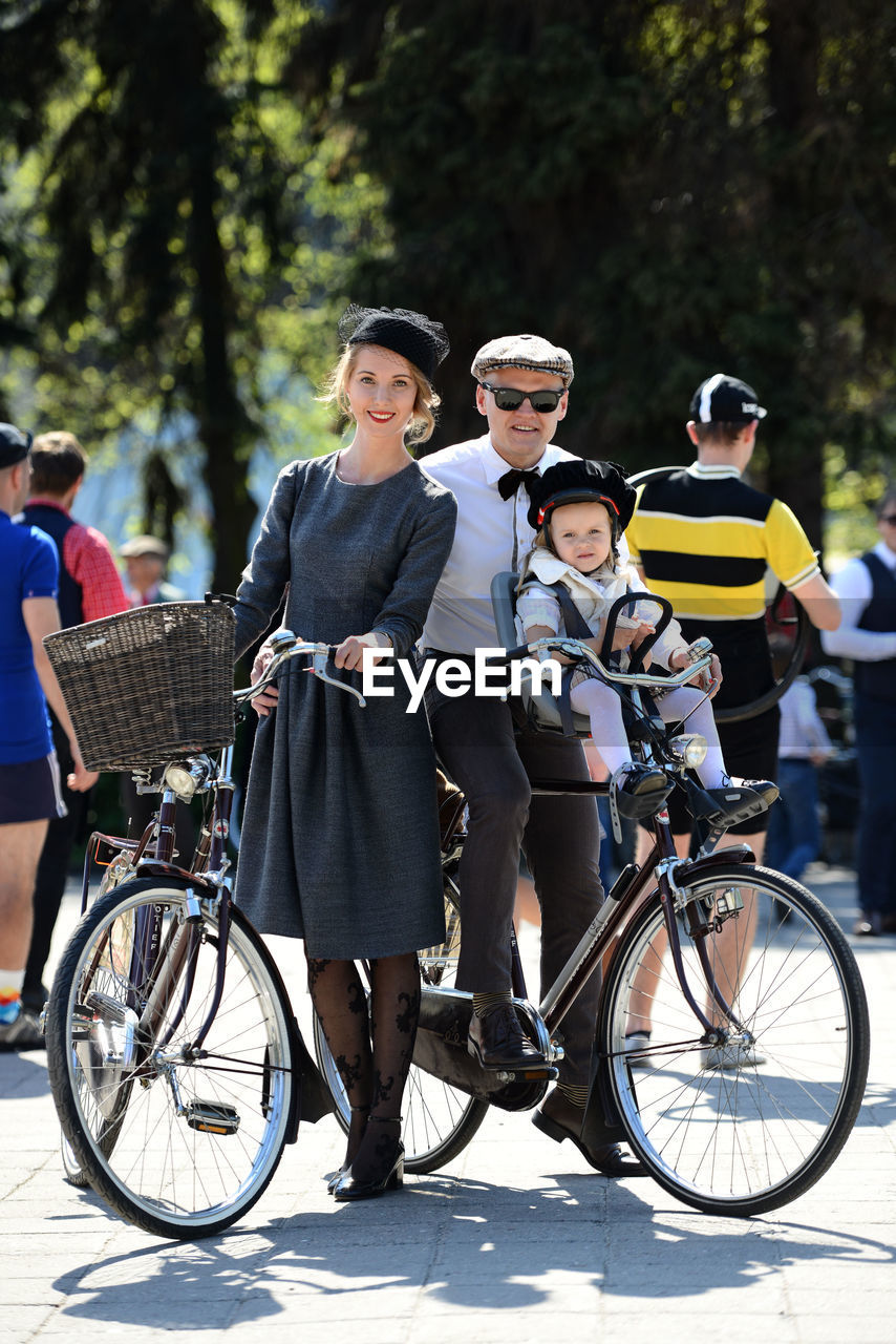 HIGH ANGLE VIEW OF PEOPLE RIDING BICYCLE ON ROAD