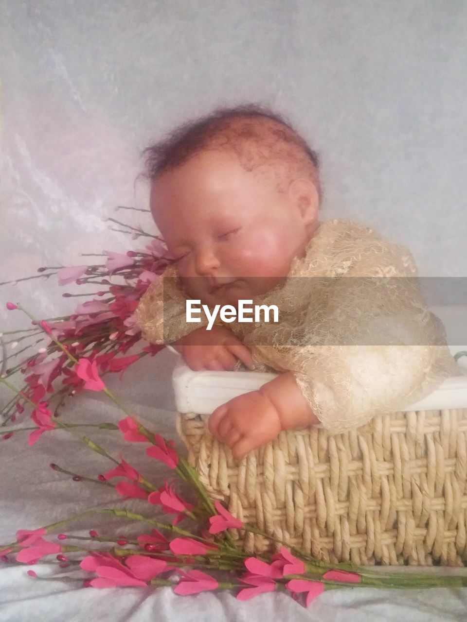 CLOSE-UP OF CUTE BABY GIRL WITH FLOWERS