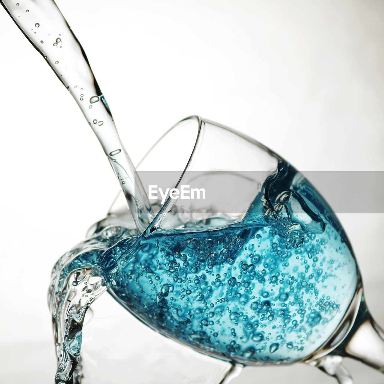 CLOSE-UP OF WATER DROP ON WHITE SURFACE