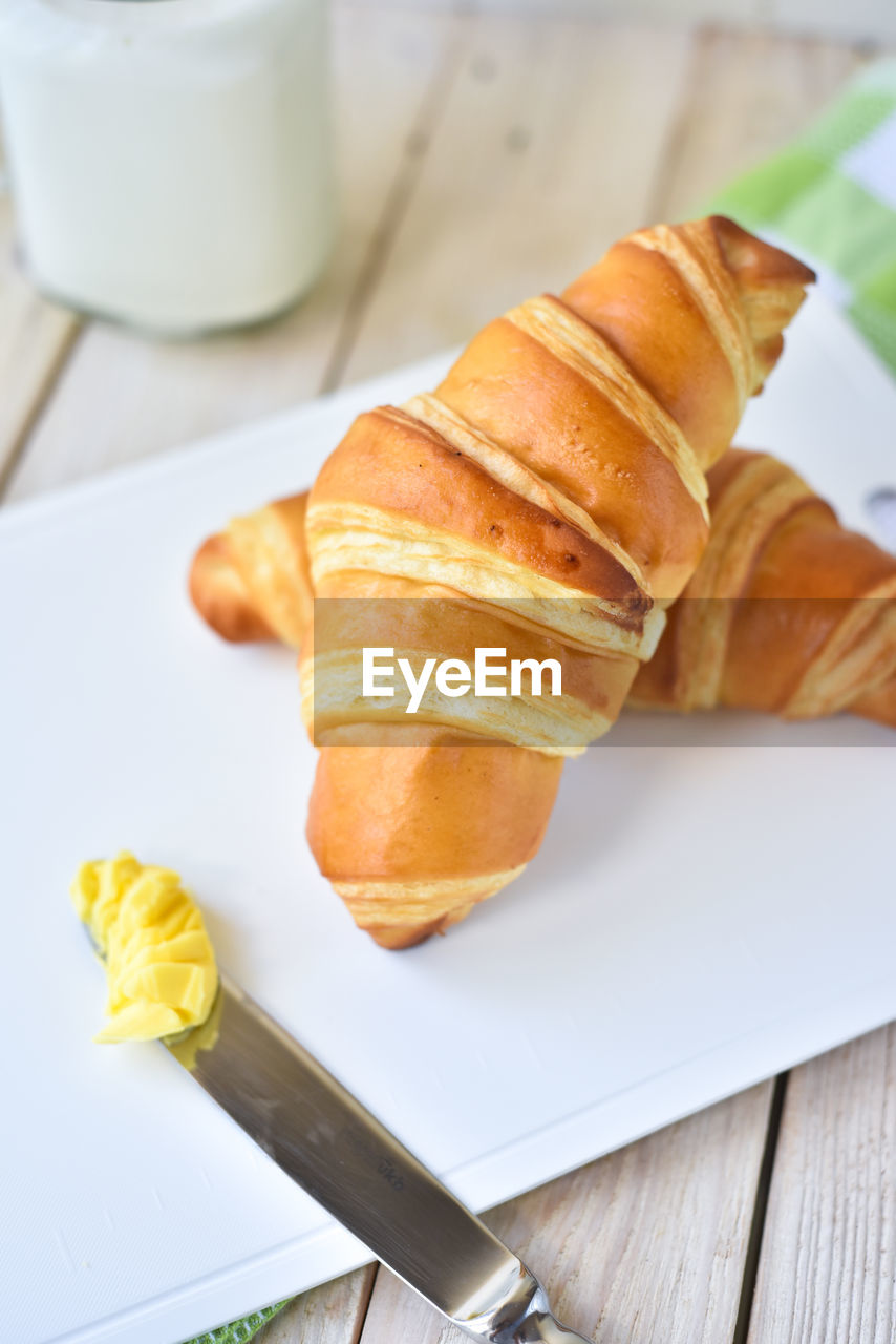 Close-up of croissants in plate on table