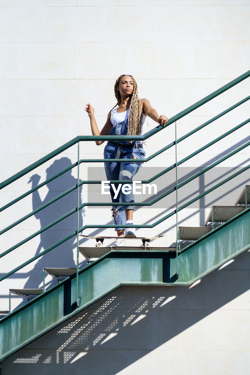 Low angle view of woman standing on staircase