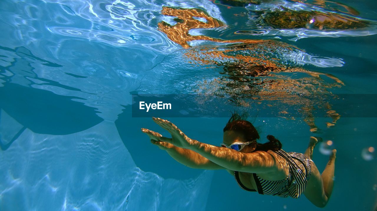 Full length of woman swimming in water