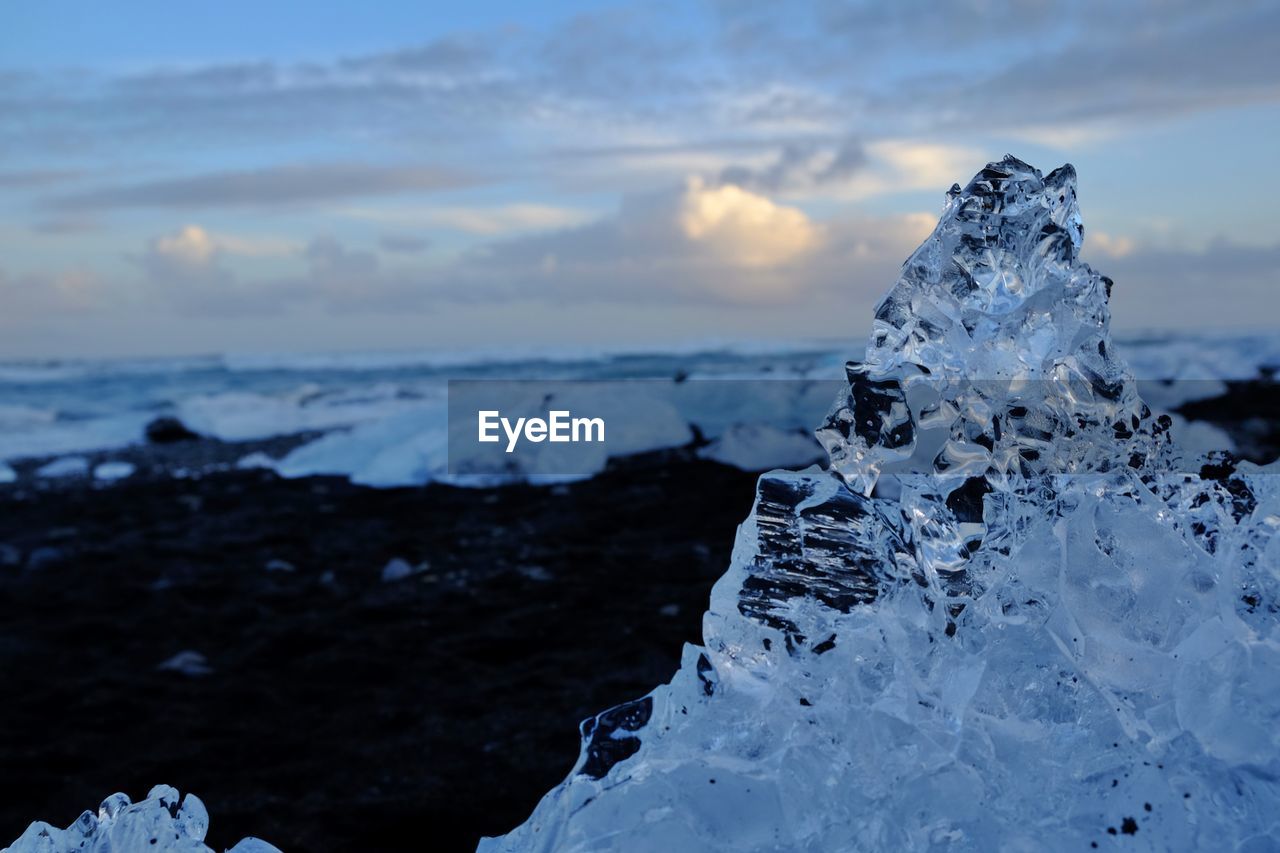 Frozen sea against sky