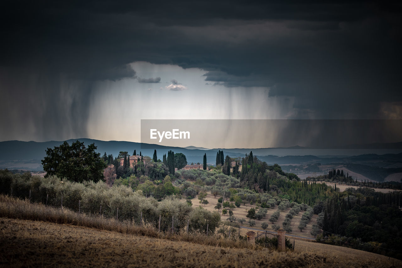 cloud, sky, environment, landscape, storm, beauty in nature, darkness, nature, scenics - nature, plant, land, thunderstorm, storm cloud, night, tree, dramatic sky, thunder, no people, outdoors, lightning, dusk, horizon, evening, mountain, architecture, power in nature, travel destinations