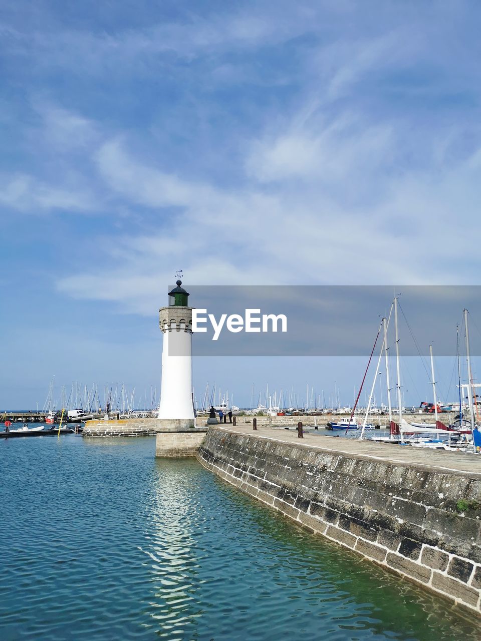 lighthouse, architecture, water, built structure, guidance, sky, sea, building exterior, tower, building, transportation, nautical vessel, nature, harbor, coast, cloud, travel destinations, travel, channel, security, day, protection, no people, blue, ocean, pier, outdoors, beach, mode of transportation, tourism, ship, city, bay, coastline, land, the past, history, waterfront, sailboat