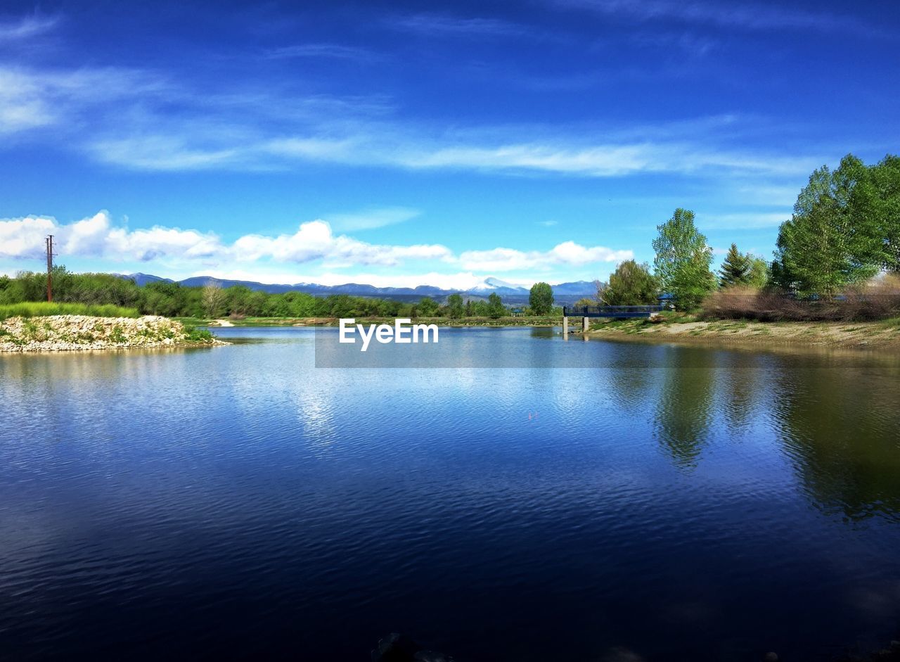 Scenic view of lake against blue sky