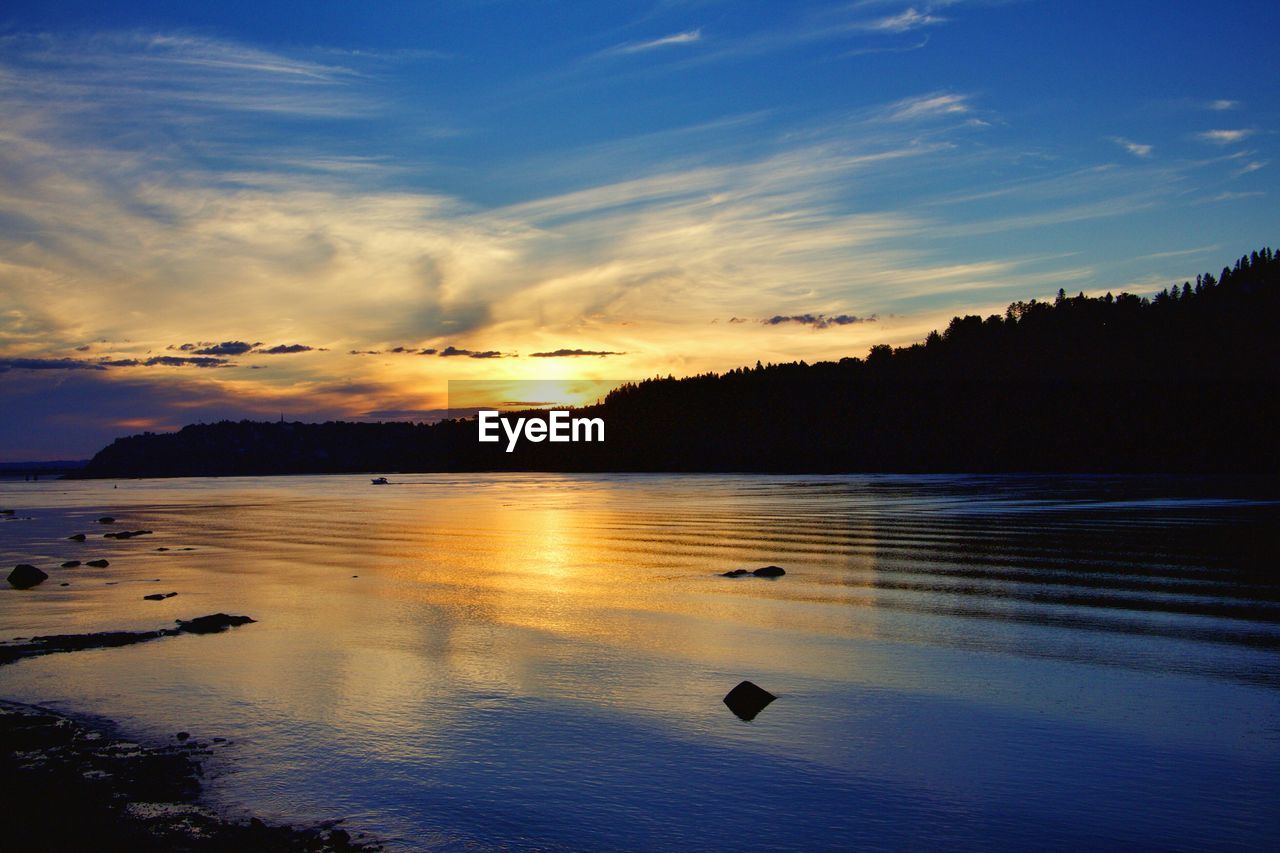 Scenic view of sunset over river