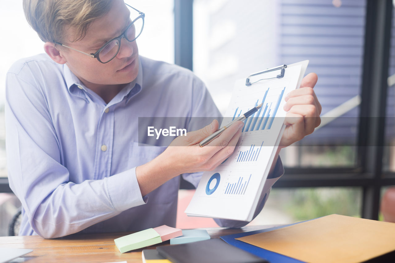 Young businessman working at desk in office