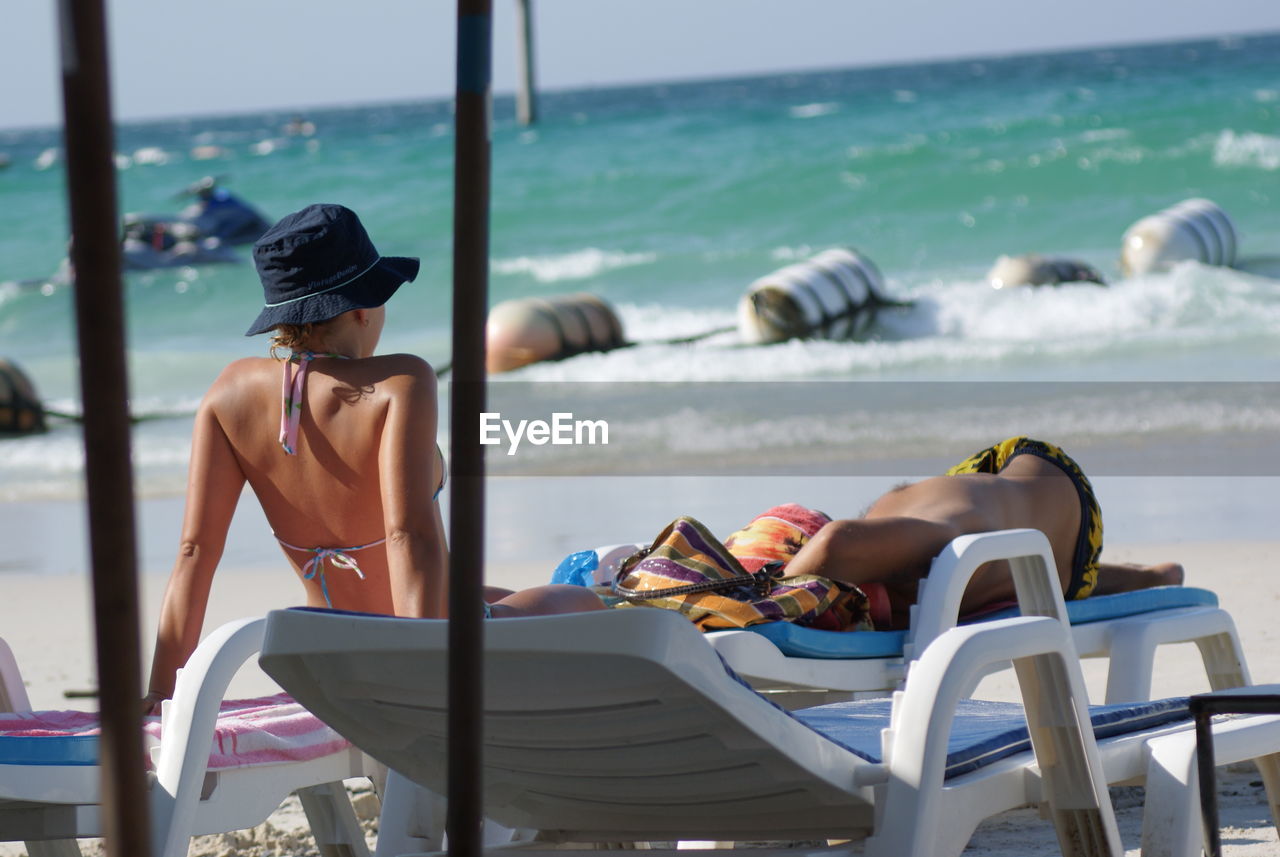 People sitting on chair at beach