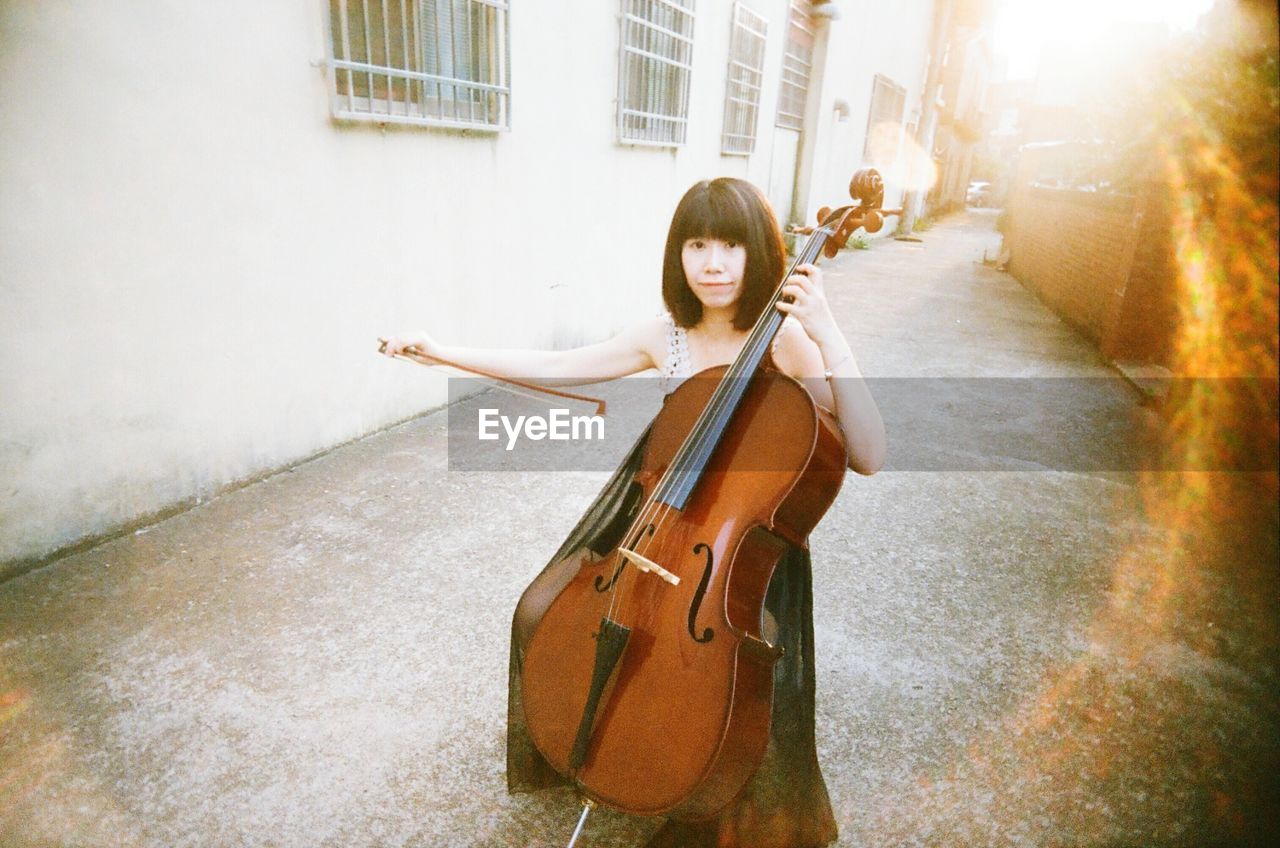 Portrait of young woman playing cello