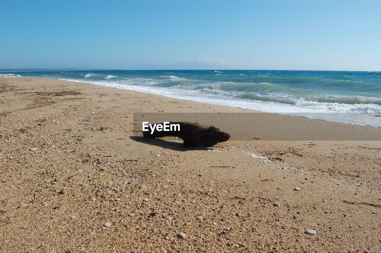 Scenic view of beach against blue sky