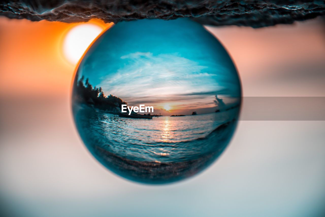 CLOSE-UP OF CRYSTAL BALL IN SEA