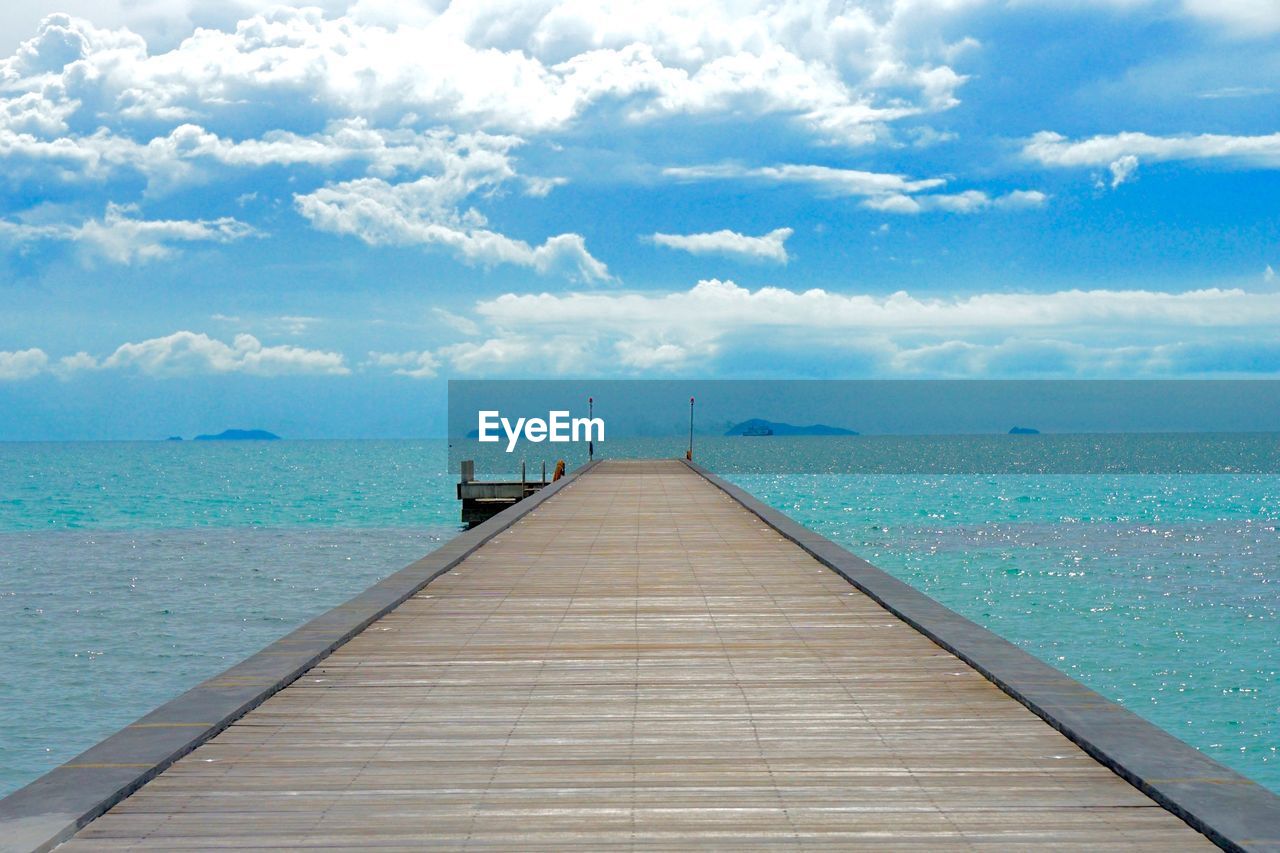 Pier over sea against sky