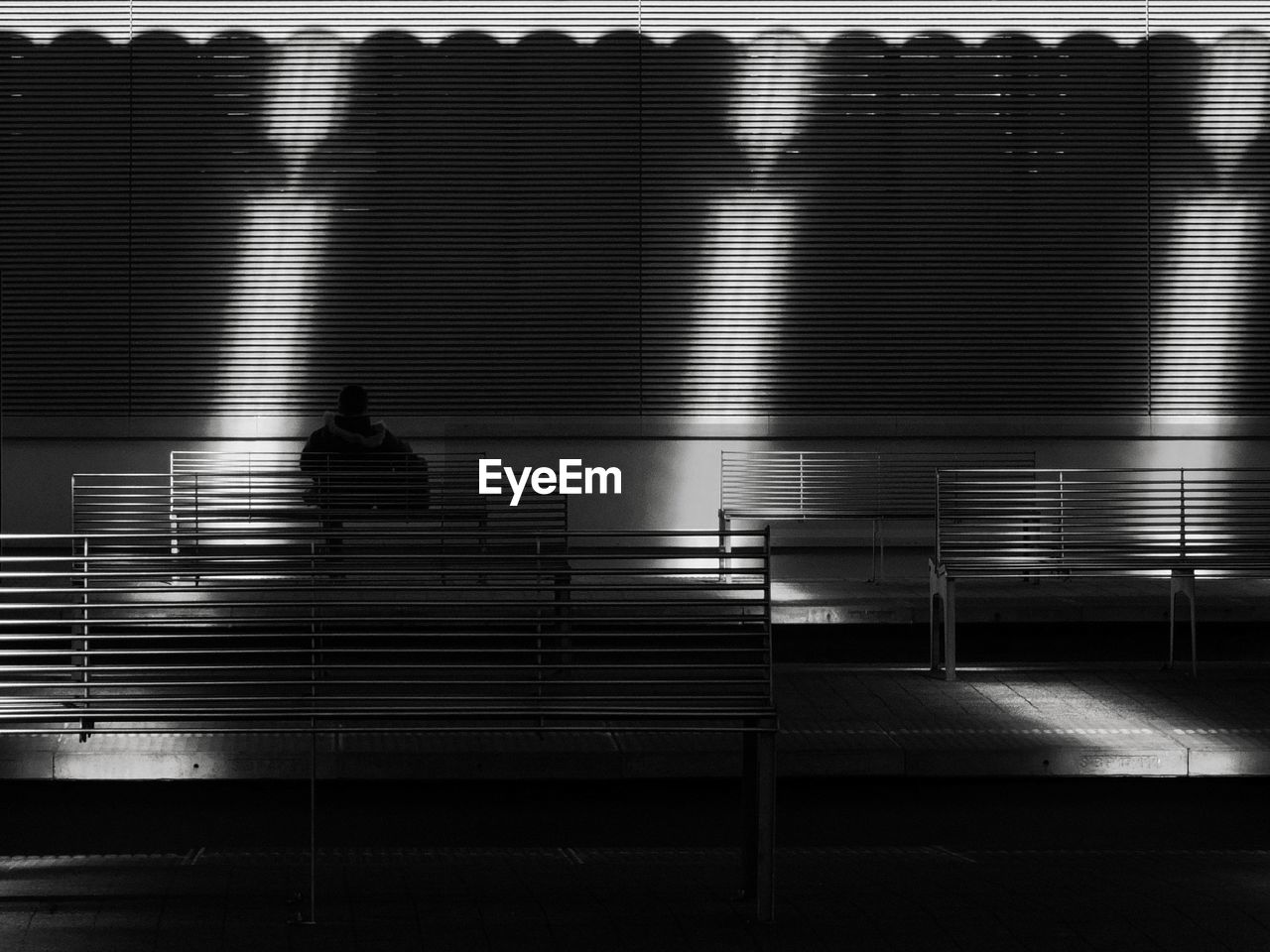 SHADOW OF PEOPLE SITTING ON STAIRCASE IN CITY