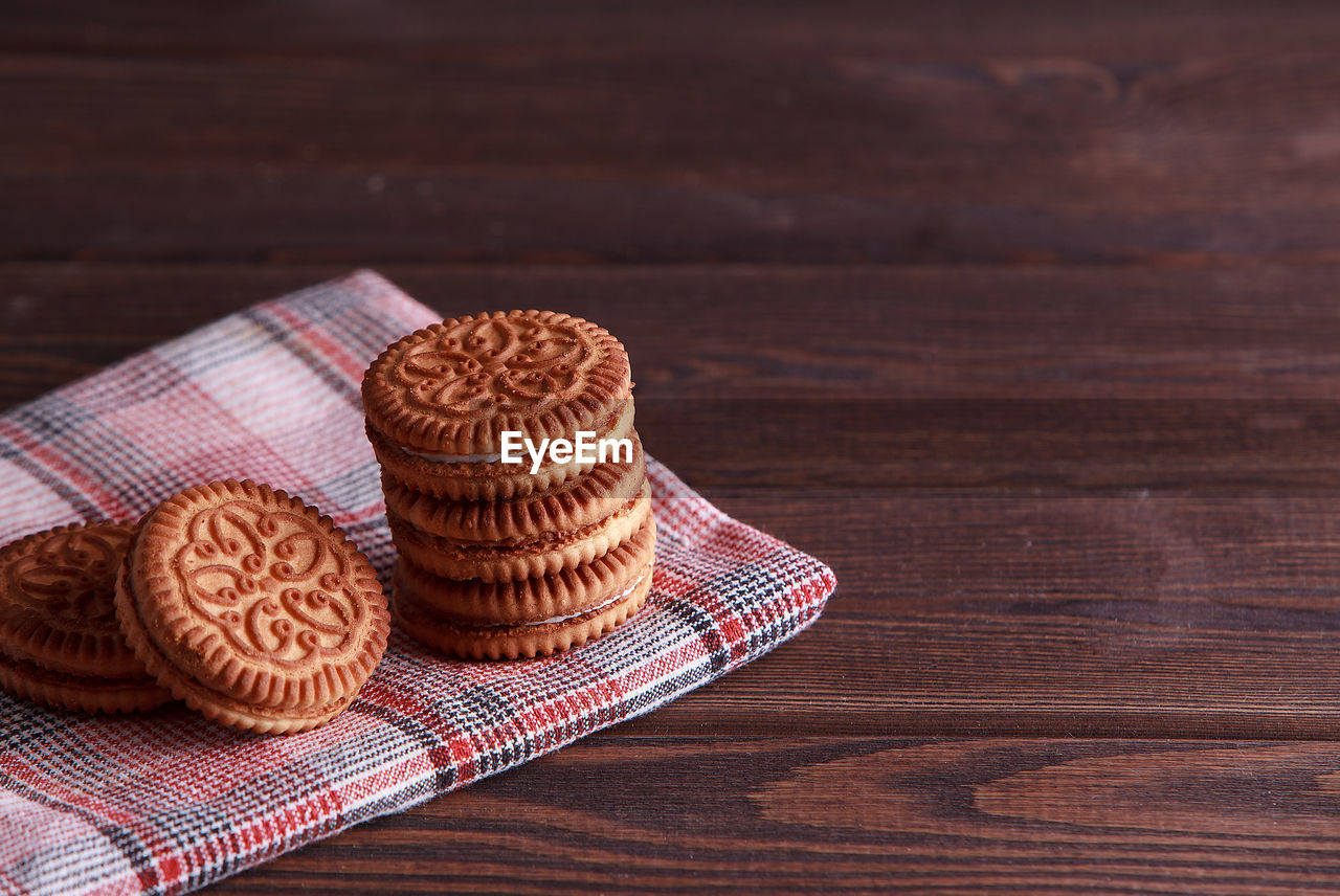 Sandwich biscuits, cream biscuits, cookies with cream filling on wooden table