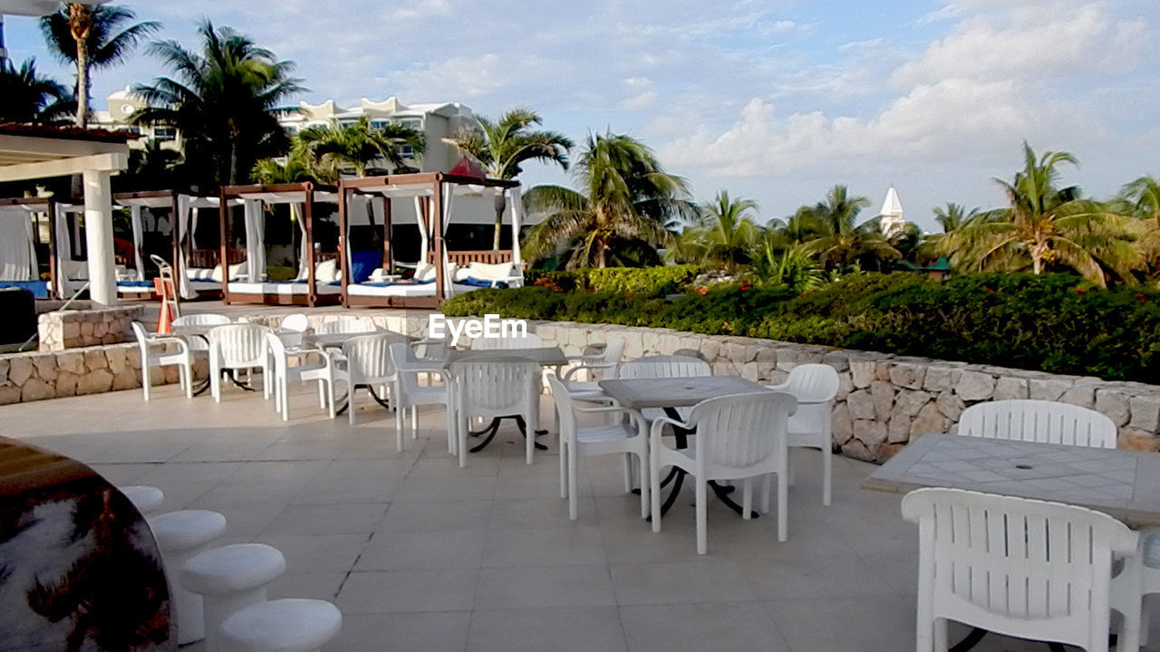 CHAIRS AND TABLE AT BEACH