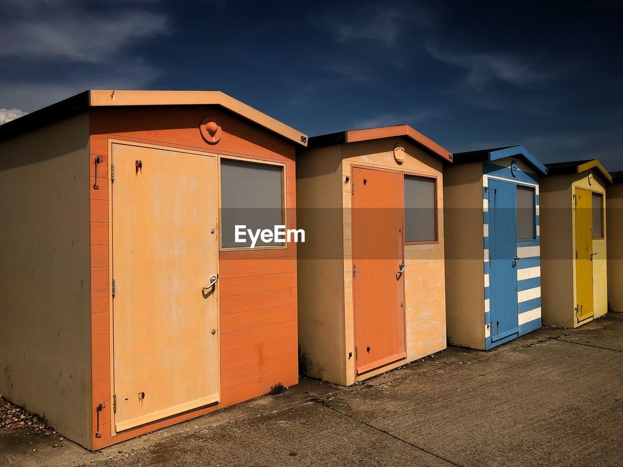 BEACH HUTS AGAINST SKY