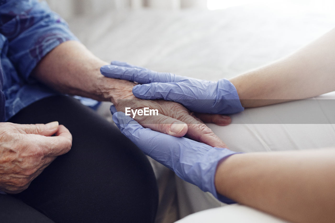 Nurse holding woman's hand