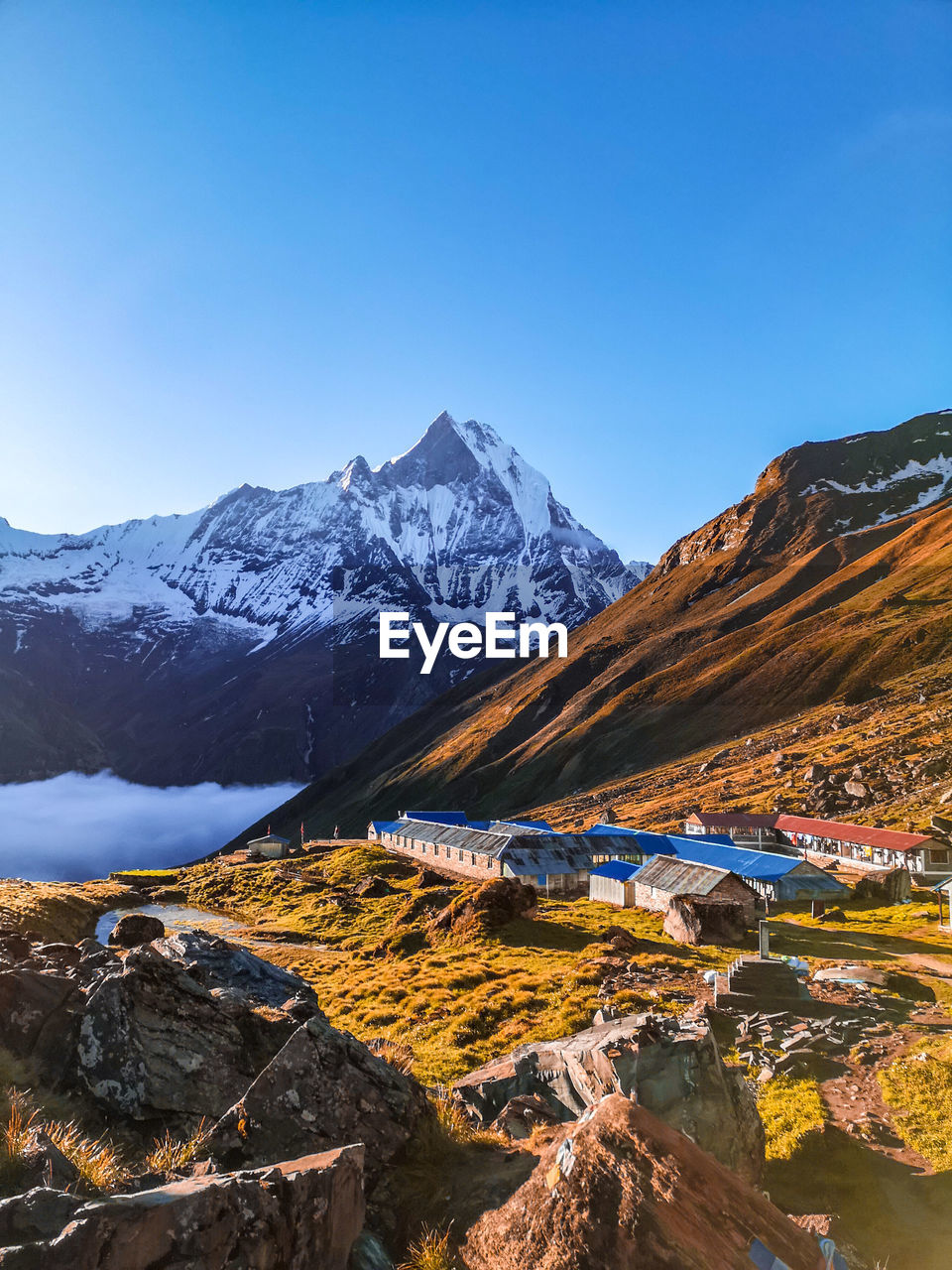 Scenic view of mountains against clear blue sky