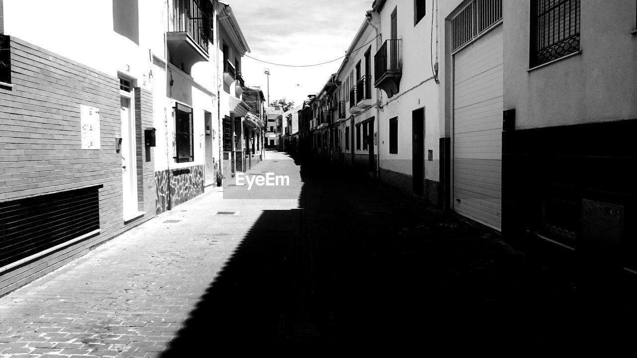 Narrow alley amidst buildings in city