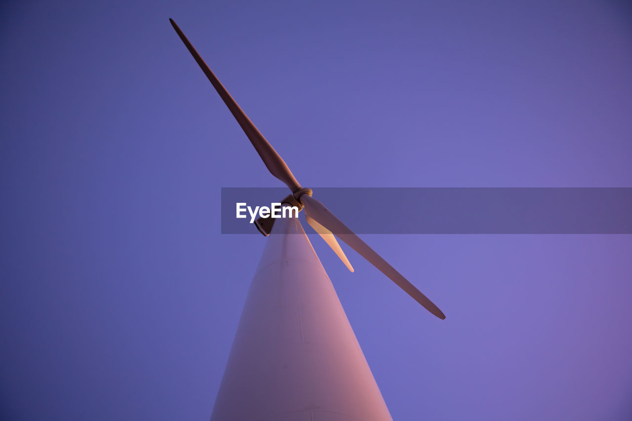 Wind turbine with purple sky during dusk
