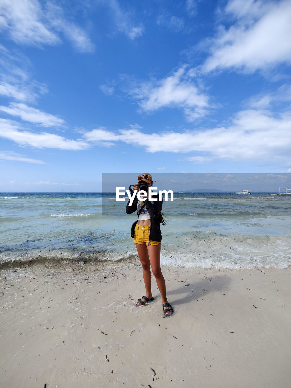 land, beach, sea, sky, water, full length, body of water, adult, ocean, nature, vacation, sand, holiday, shore, cloud, leisure activity, trip, women, coast, beauty in nature, one person, lifestyles, young adult, horizon, standing, horizon over water, wave, day, blue, sports, casual clothing, motion, travel, clothing, scenics - nature, female, outdoors, travel destinations, summer, emotion, person, happiness, walking, sunlight, copy space, front view, relaxation