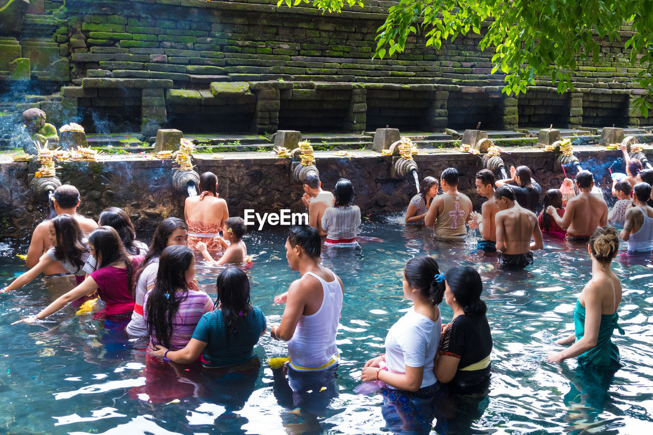 GROUP OF PEOPLE ENJOYING IN SWIMMING POOL