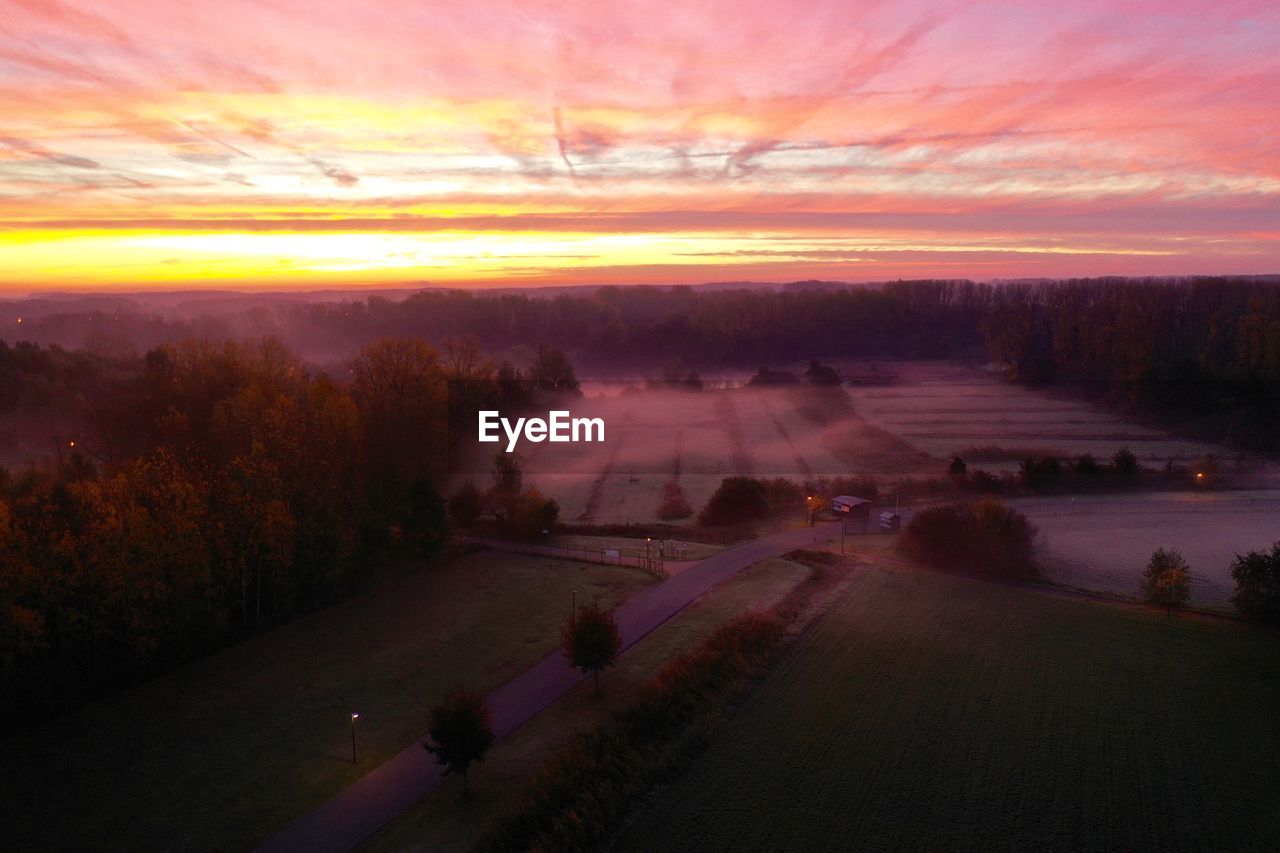 Aerial view of landscape against sky during sunset