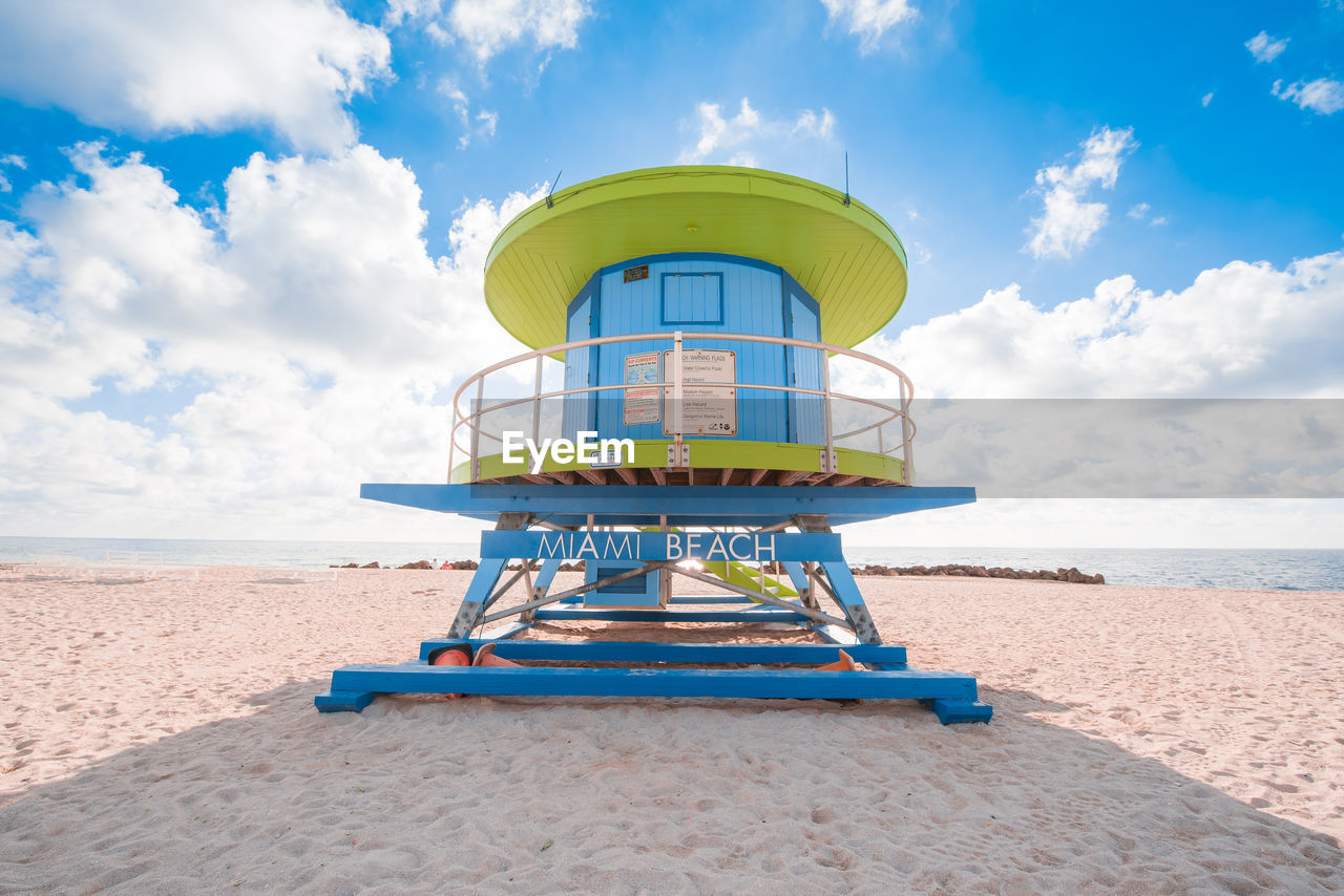 Lifeguard hut on beach against sky