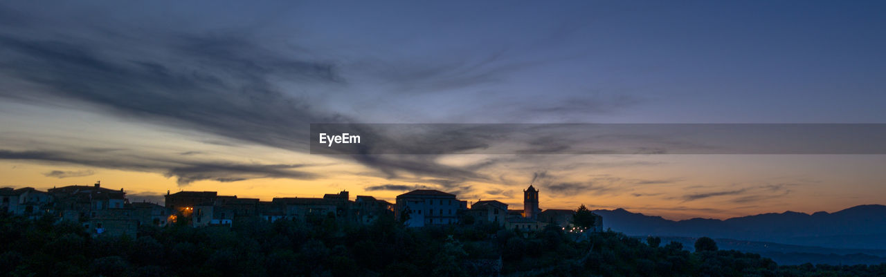 View of cityscape against cloudy sky