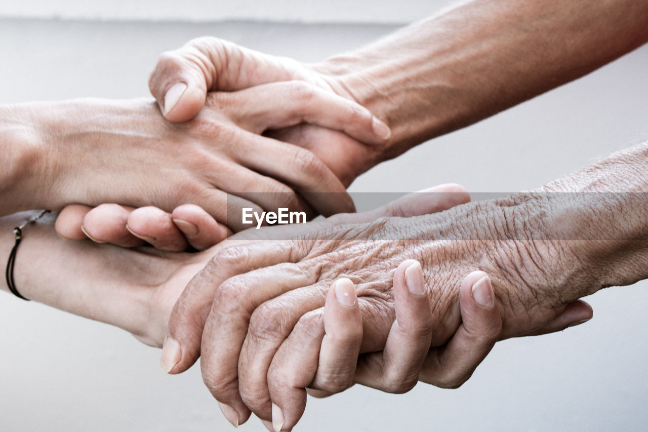 MIDSECTION OF COUPLE HANDS WITH BABY