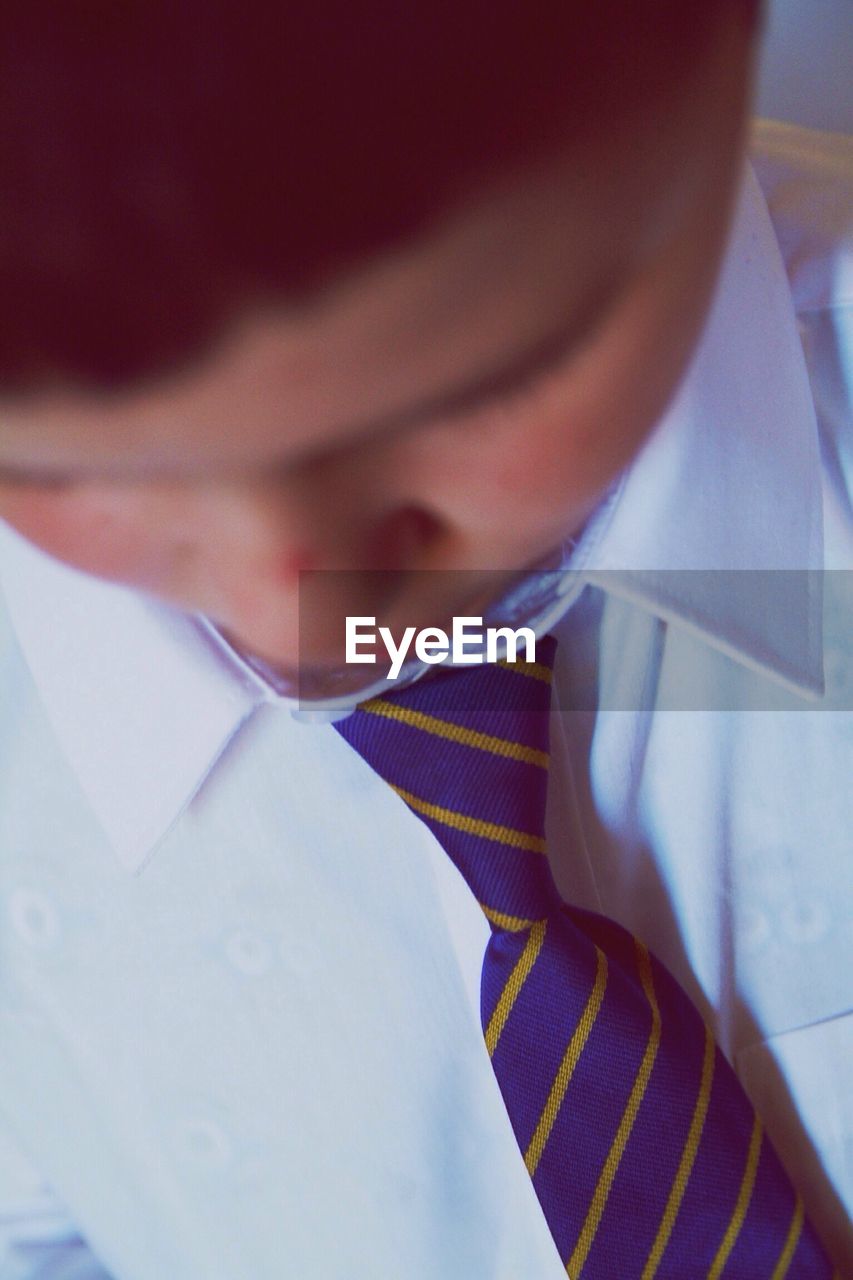 Close-up of boy wearing shirt and tie