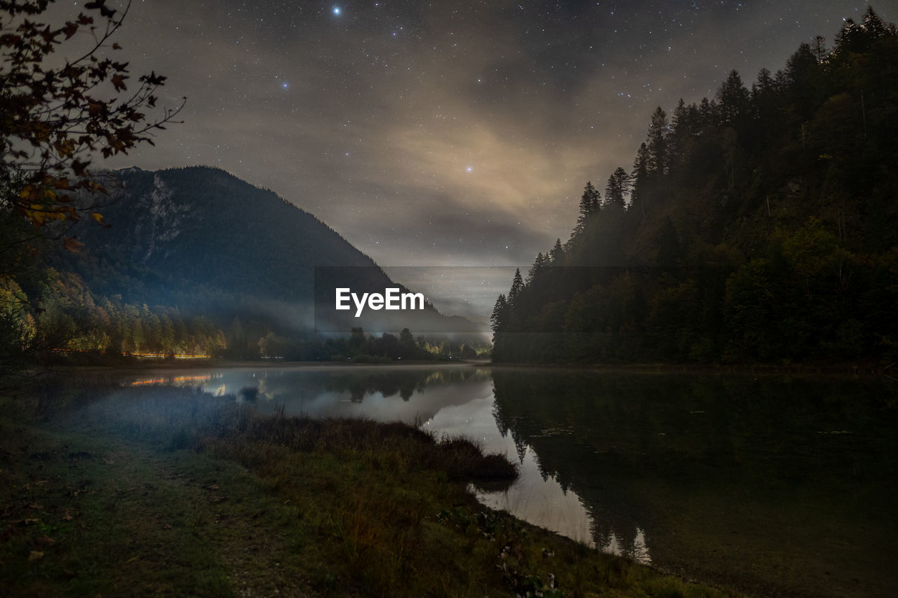 Scenic view of lake against star field in sky at night