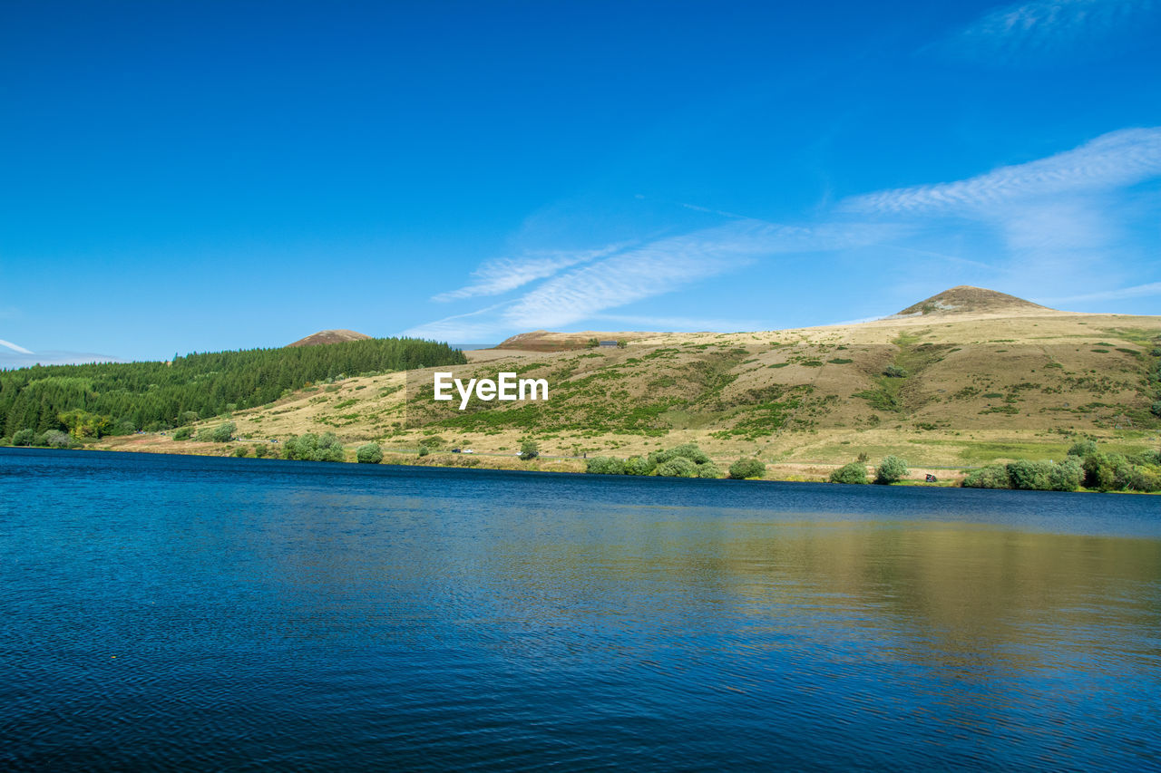 Scenic view of lake against blue sky