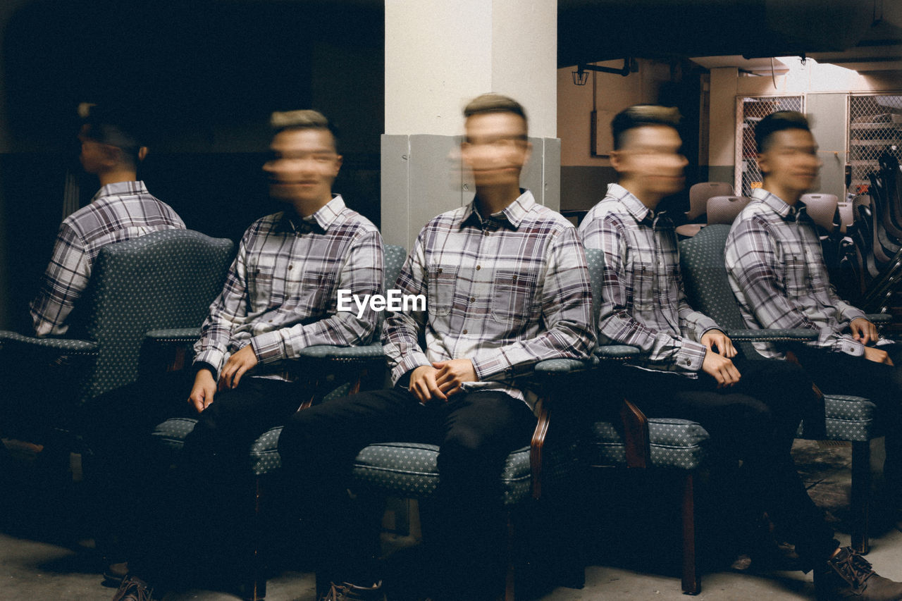 Surreal multiple exposure of man in basement