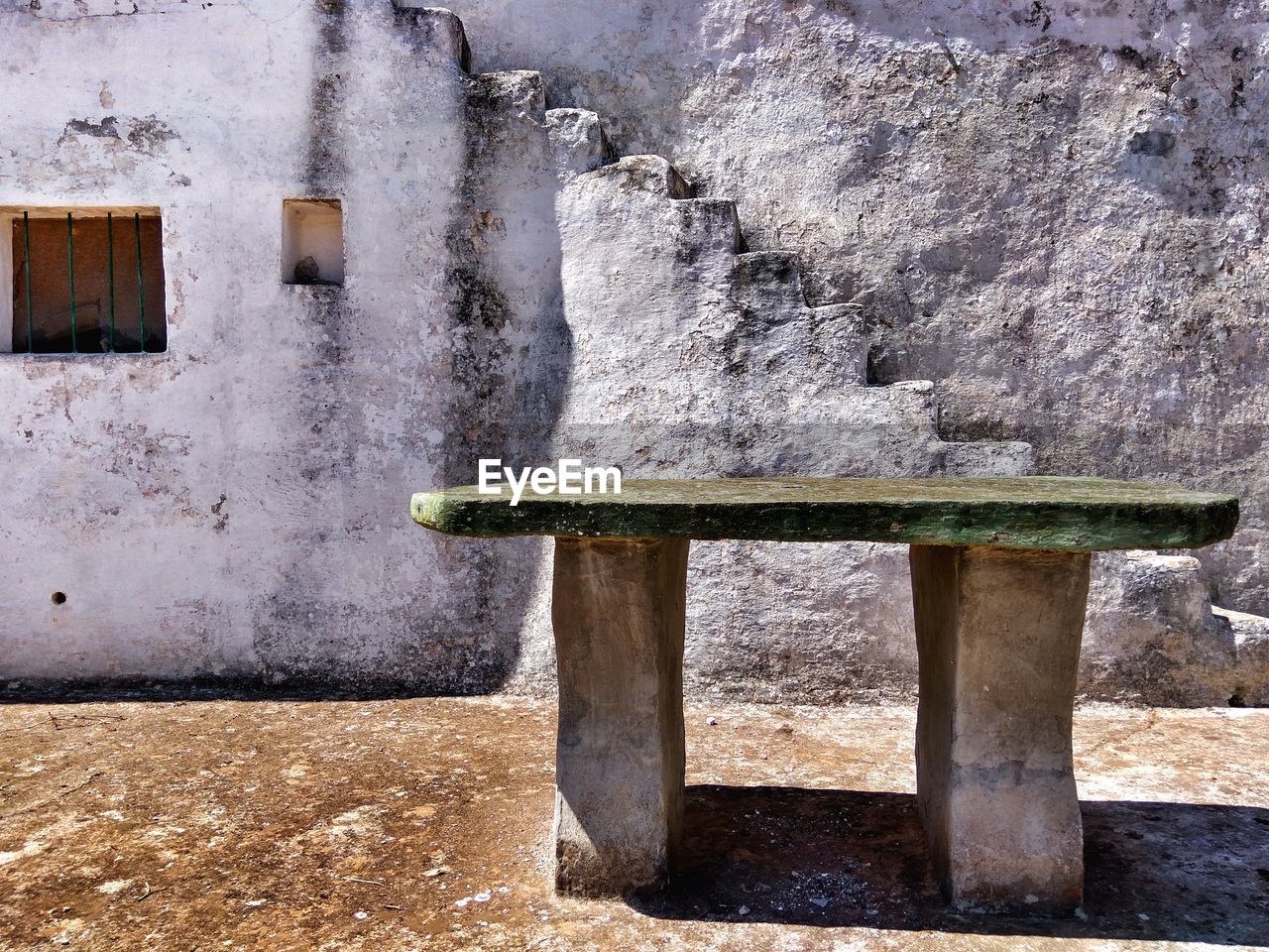 Table against old house in town