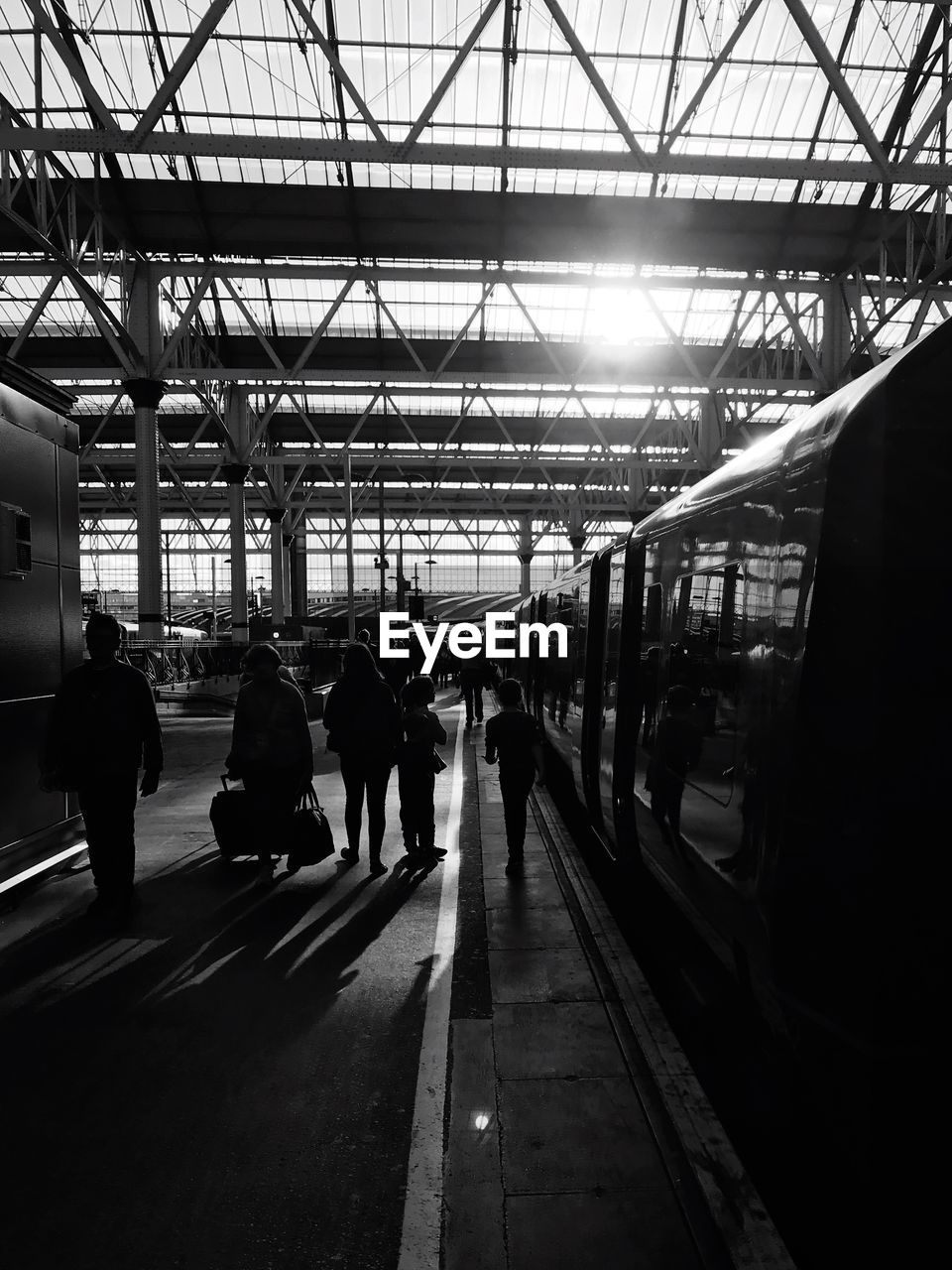 PEOPLE ON RAILROAD STATION PLATFORM